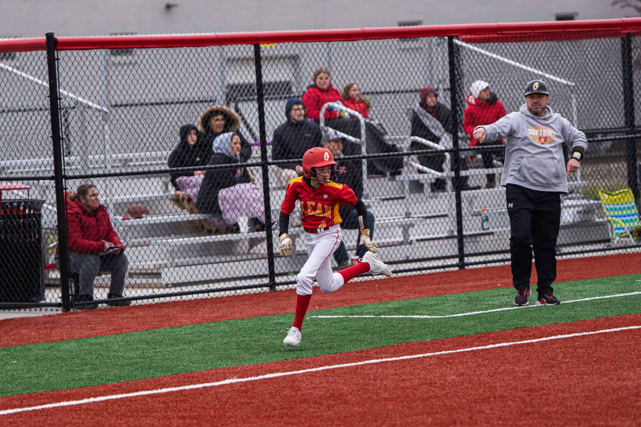 Olean's Riley Sudbrook clears third base on her way across home during the Huskies' season-opening loss to Randolph. | Photo by Hunter O. Lyle